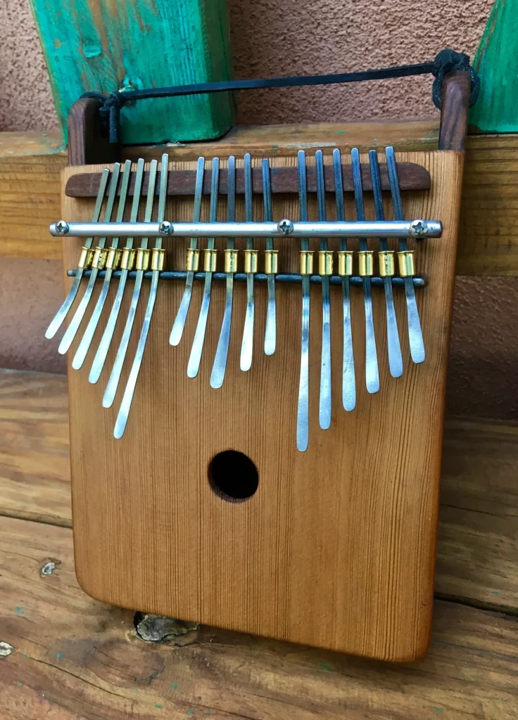 An African Ngoma instrument made of wood, featuring metal tines.