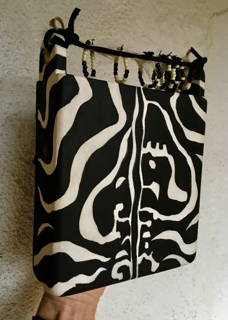 A person holding a zebra print bag.