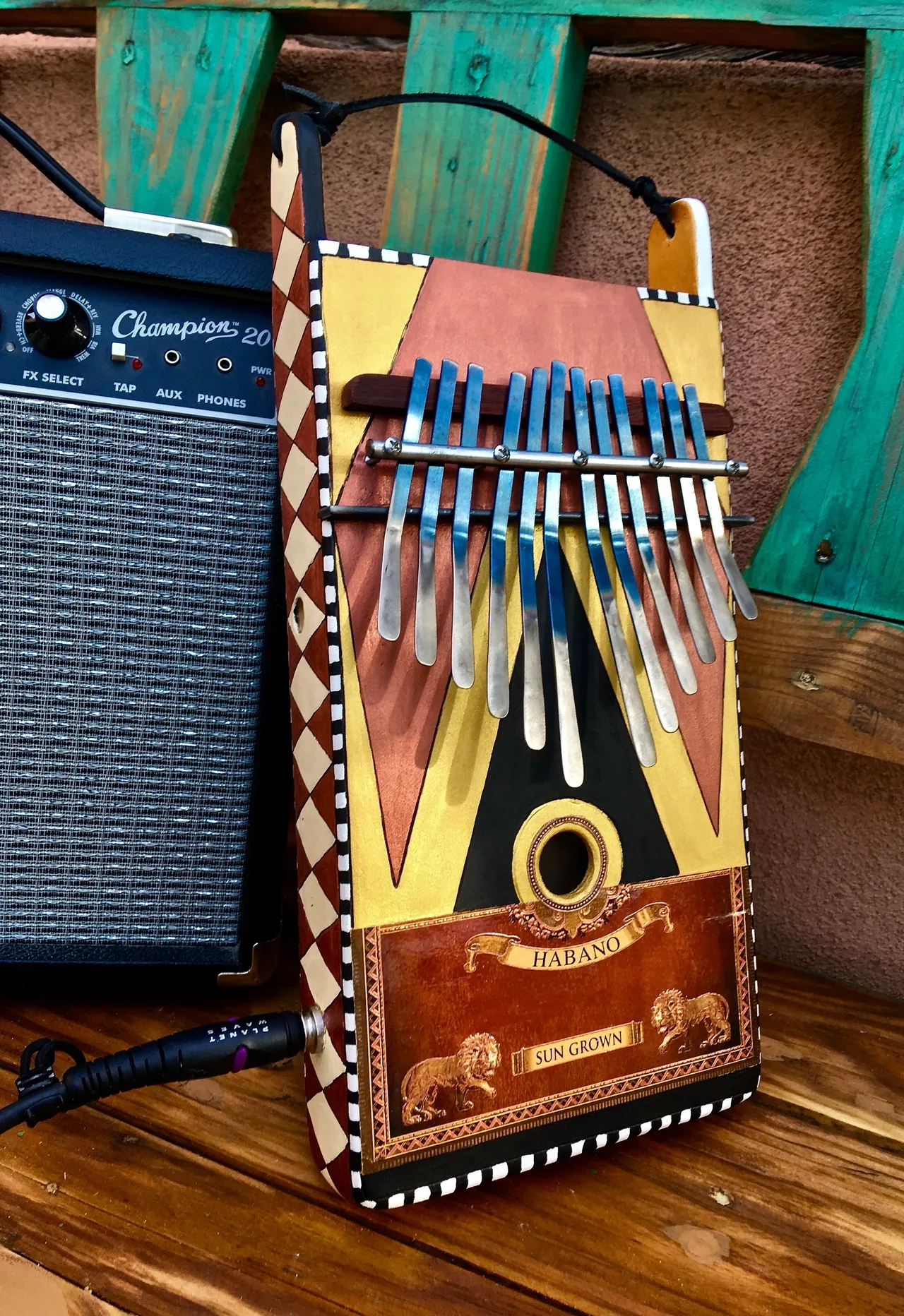 A lamellaphone sitting on a wooden bench.