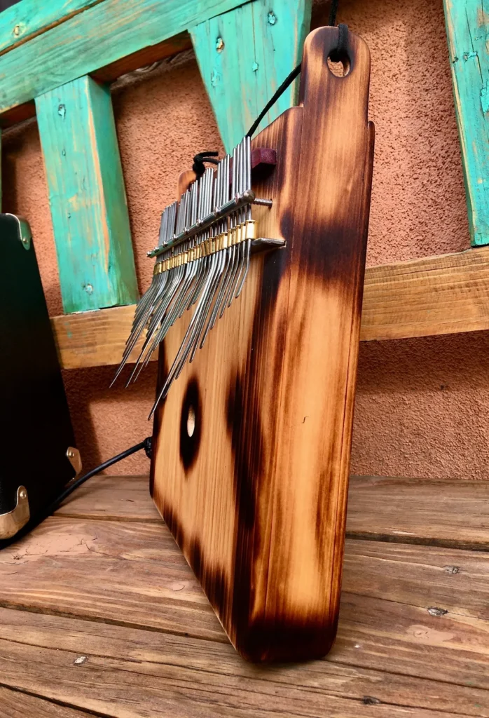 A wooden gourd instrument sitting on top of a wooden bench.