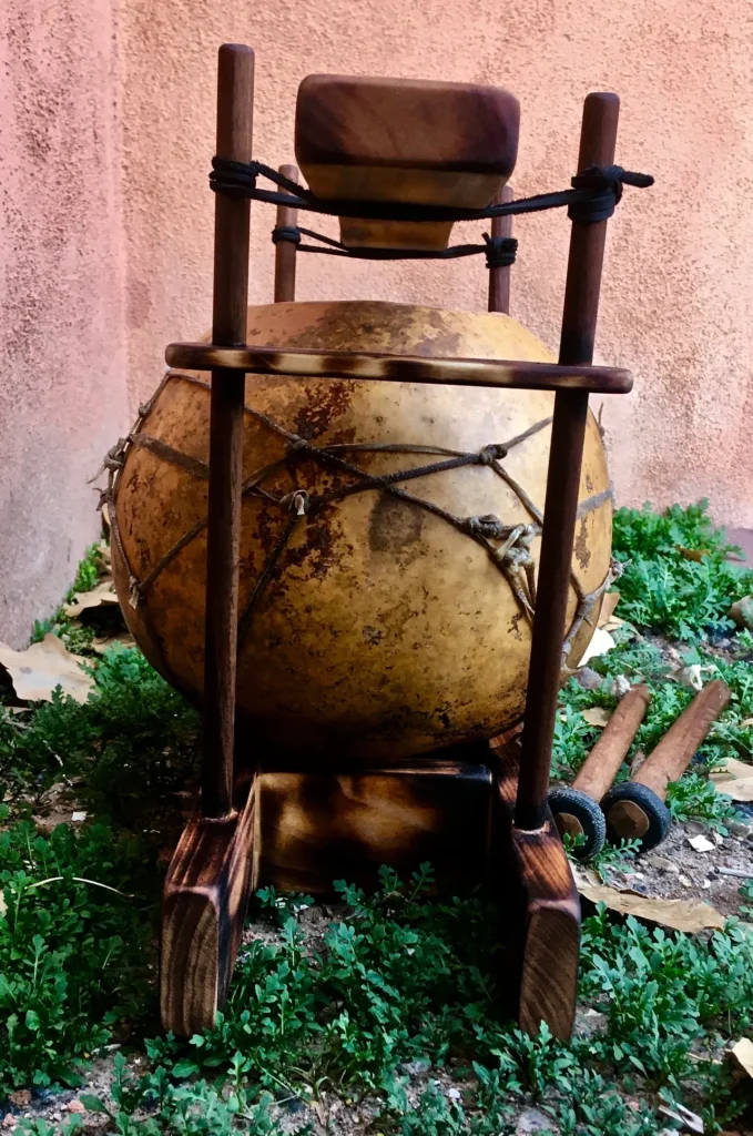 A lamellaphone drum sitting on a grassy area.