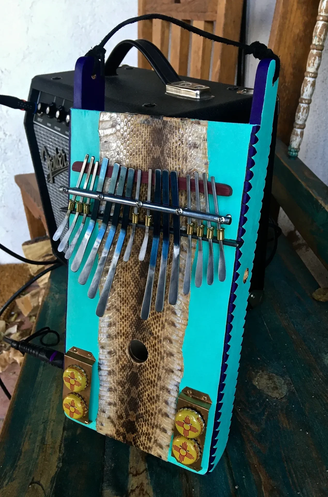 A Lamellaphone instrument is sitting on a wooden table.