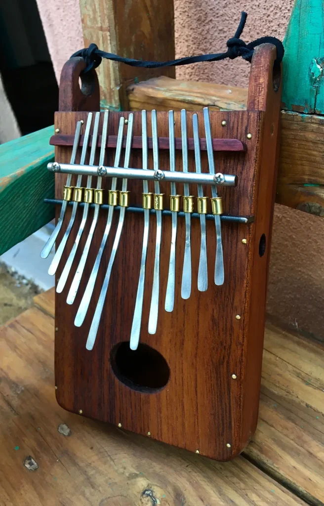 A Ngoma xylophone sitting on top of a wooden bench.