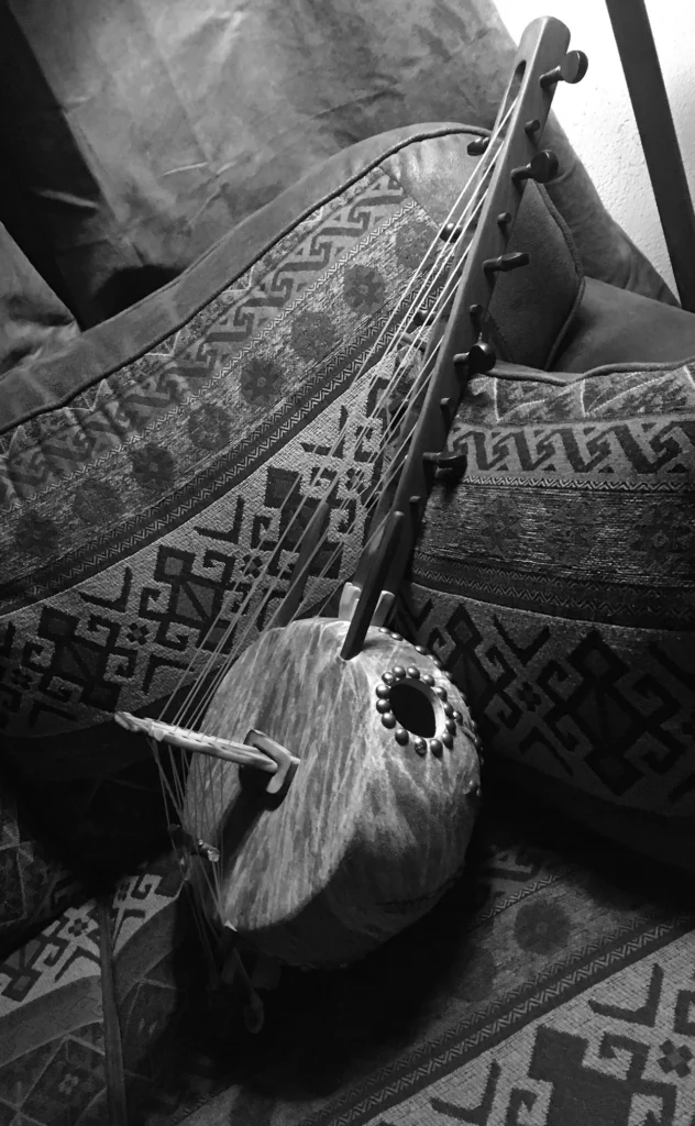 A black and white photo of a Ngoma on a bed.