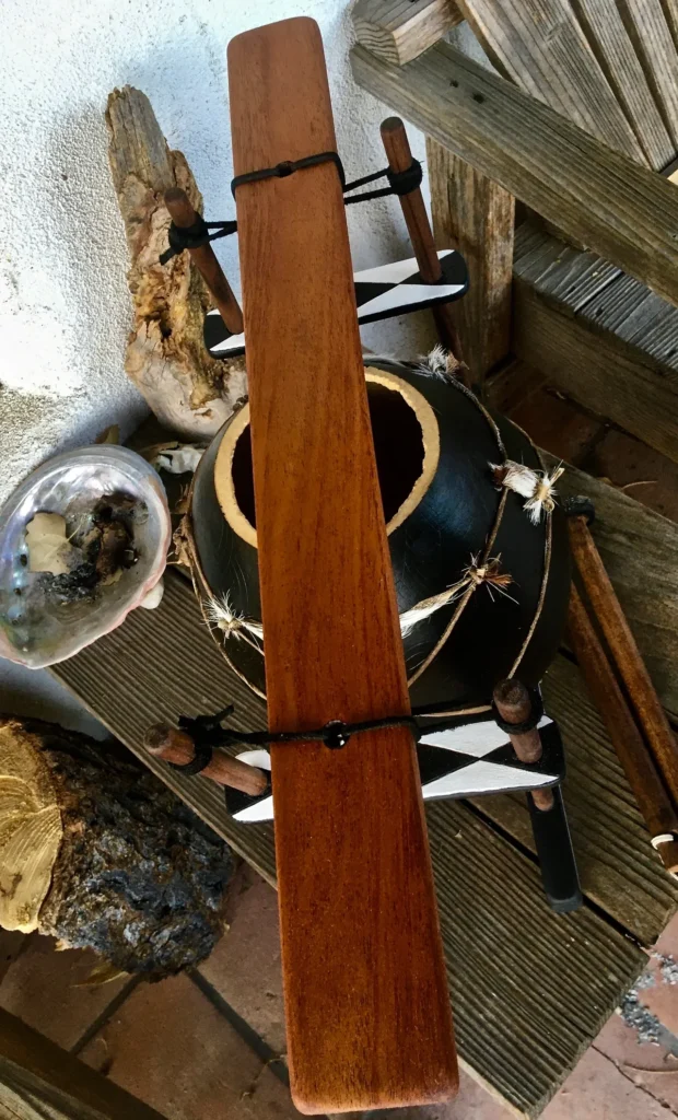 An intricately carved lamellaphone made from gourd, sitting beautifully on a rustic wooden table.