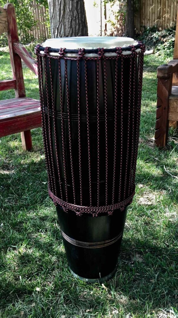 An Ilimba djembe sitting on the grass.