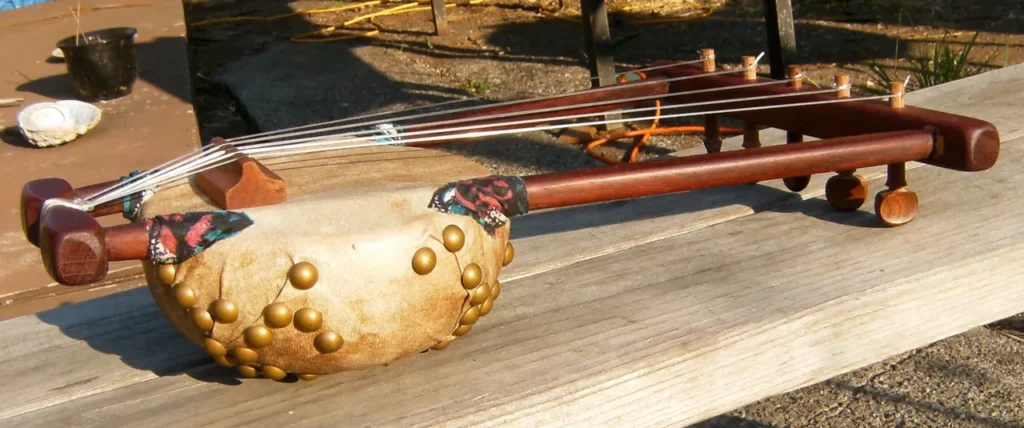 A Kalimba is sitting on a wooden table.