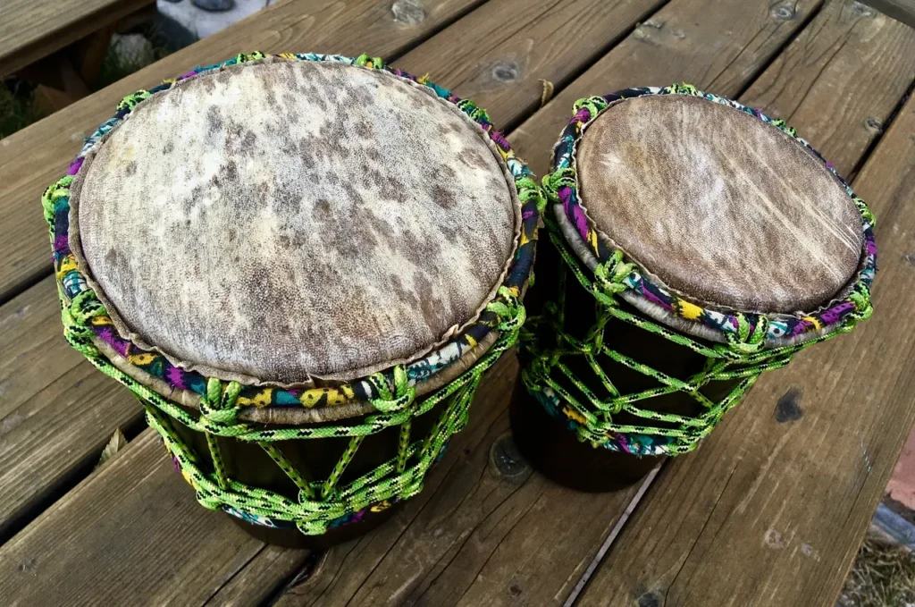 Two Ilimba drums on a wooden table.