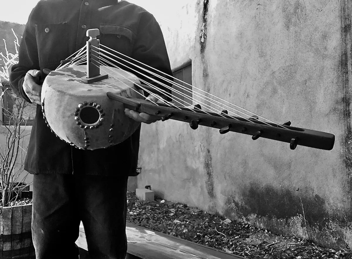 A man playing a Ngoma, an African musical instrument.