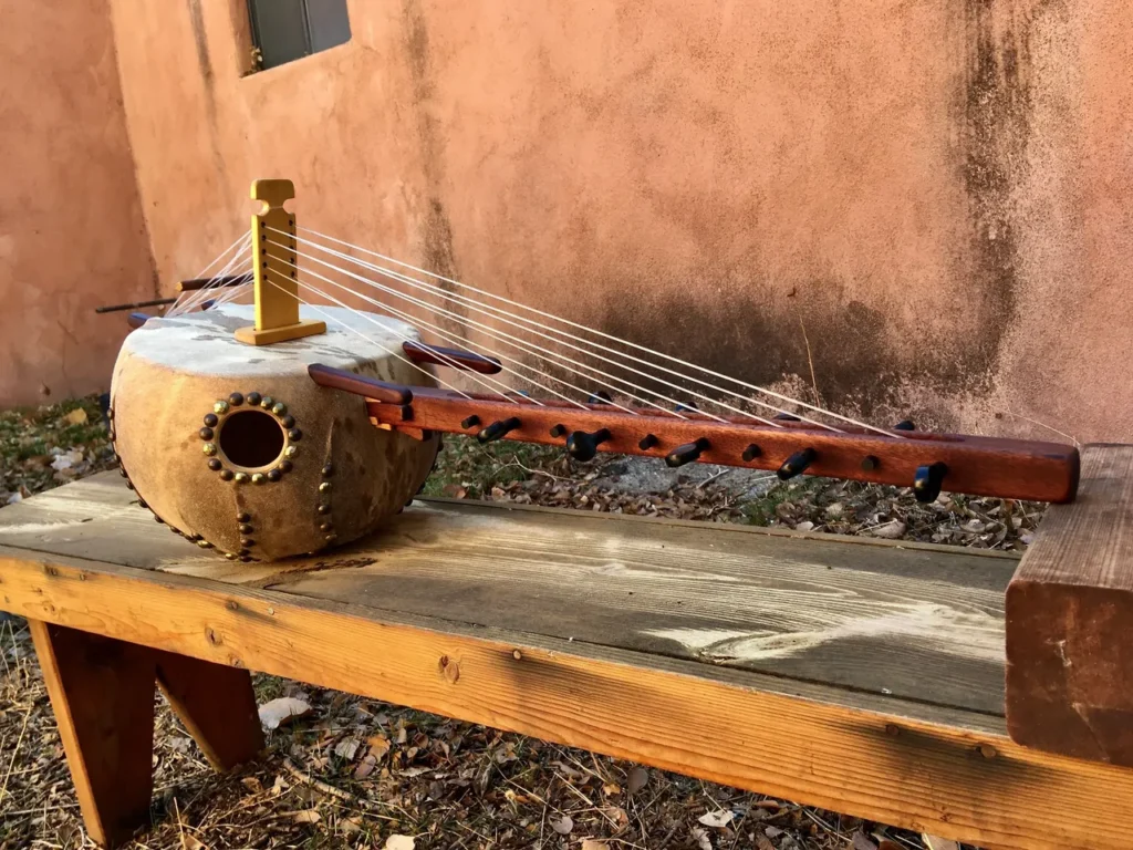 A Ngoma, an African musical instrument, is sitting on a wooden bench.