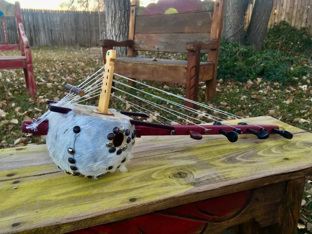 A Ngoma, an African musical instrument, resting on a wooden bench.