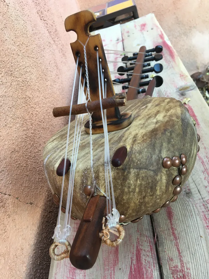 A Ngoma, a traditional African wooden instrument, is sitting on top of a wooden table.