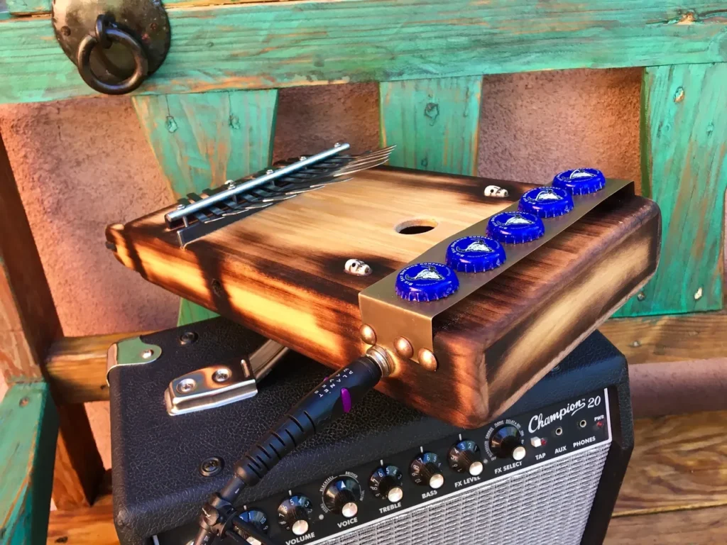 A guitar amplifier sitting on top of a wooden bench.