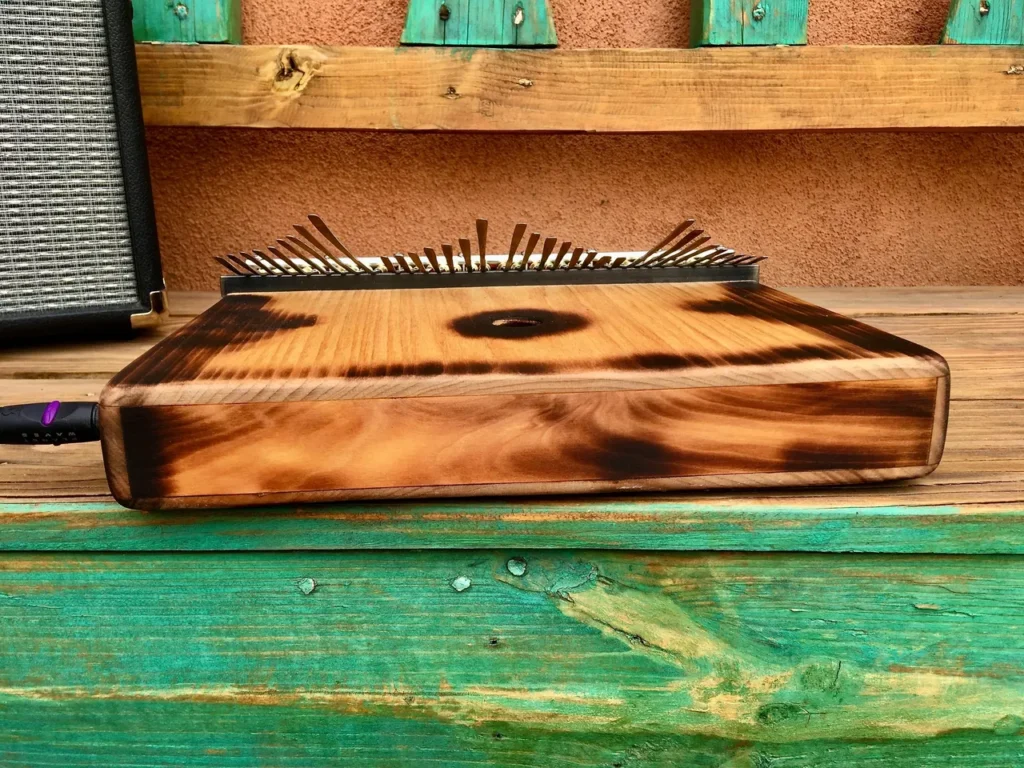 A lamellaphone sitting on top of a wooden bench.