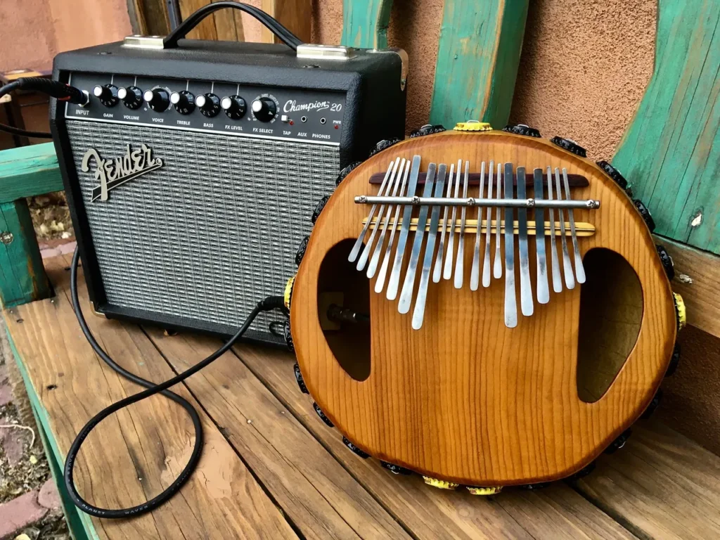 A wooden ukulele is sitting on a wooden bench.