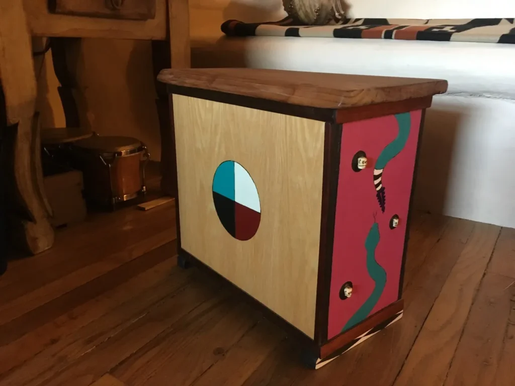 A colorful piece of furniture with an African drum design.