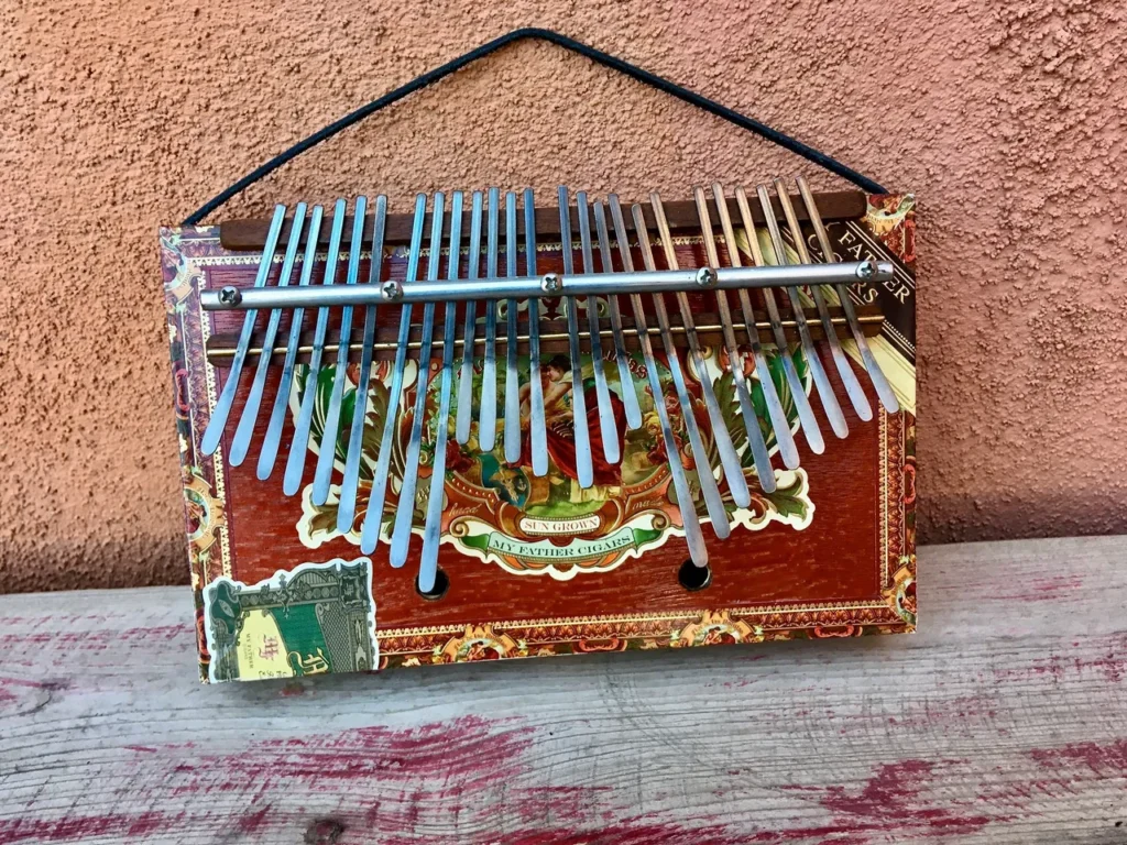 An Ngoma, a traditional African musical instrument, is resting on a wooden table.