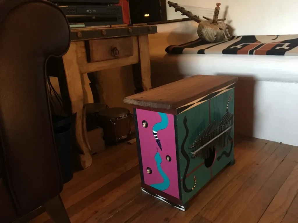 A small table with a colorful design inspired by African drum.