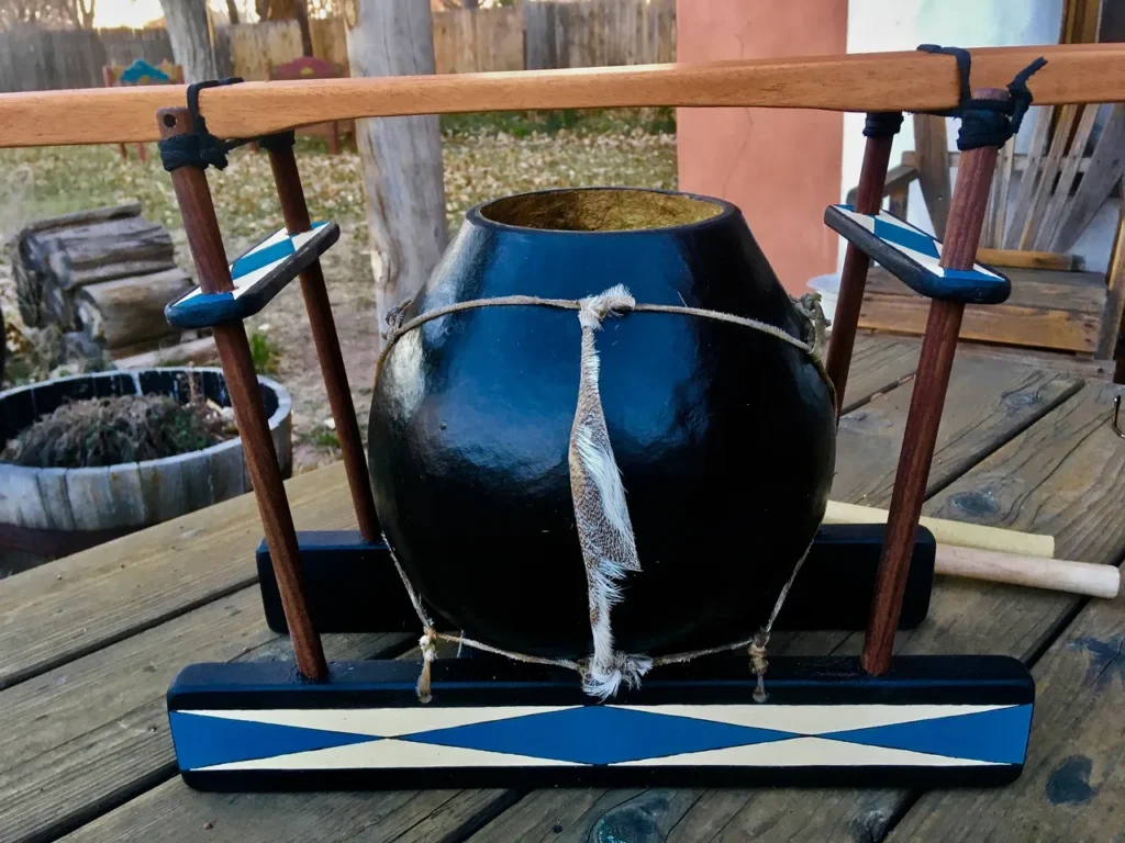 A wooden lamellaphone with a wooden handle on it.