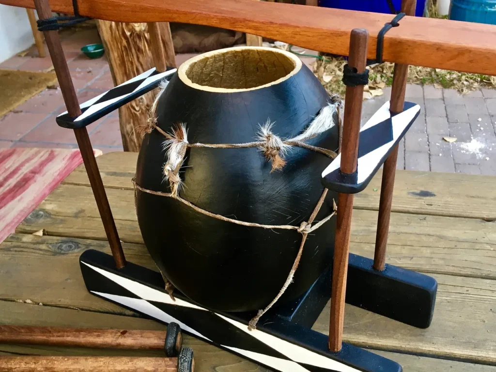 A black and white lamellaphone on a wooden table.