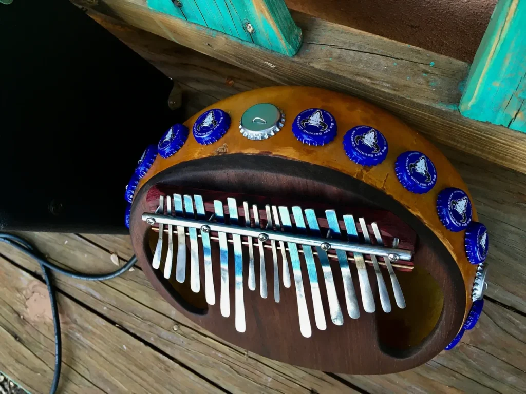 An Ilimba, a wooden musical instrument, on a wooden deck.