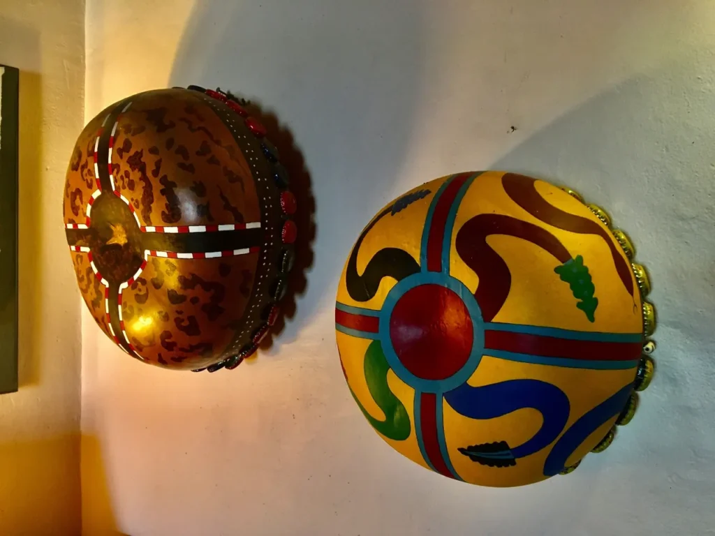 Two Ngoma drums hanging on a wall.