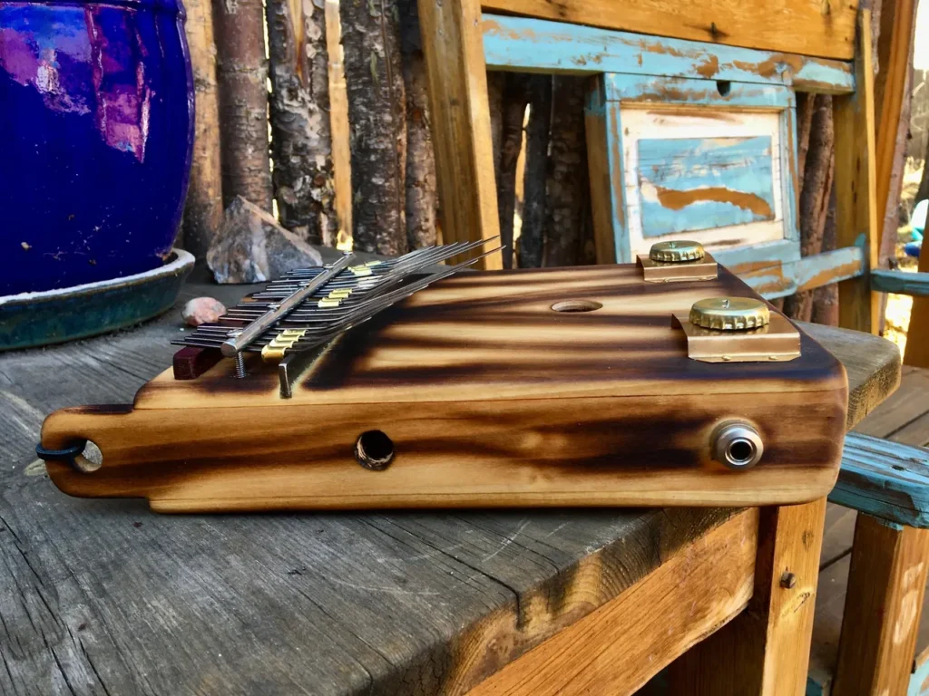 A wooden Lamellaphone sitting on a wooden bench.