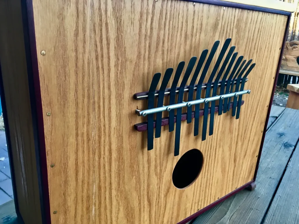 A wooden box with a kalimba inside.