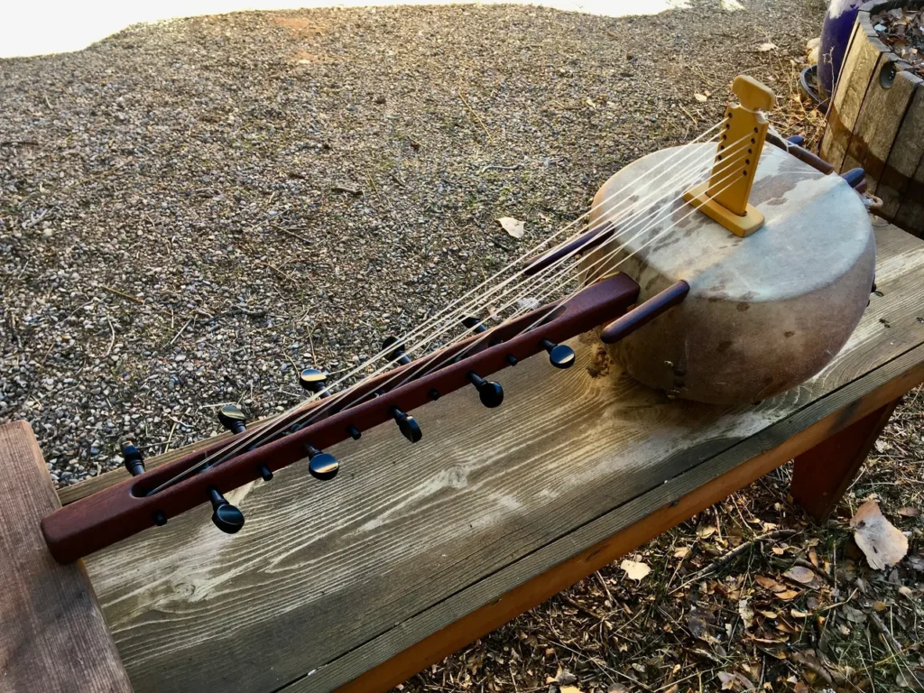 An Ngoma, a traditional African wooden instrument, sitting on top of a wooden bench.