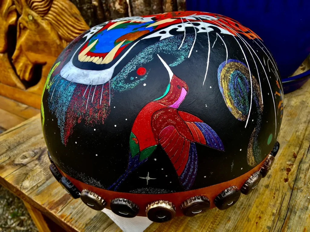 A motorcycle helmet with a colorful African harps design on it.