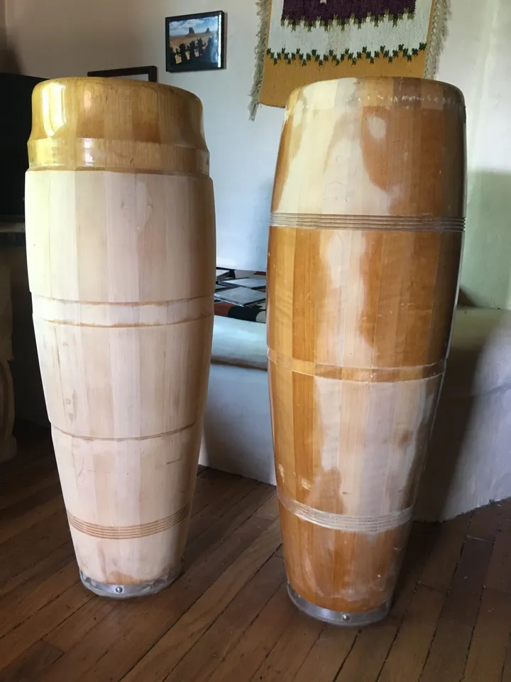 Two wooden barrels, made of Ilimba wood, sitting on a Kongoma wooden floor.