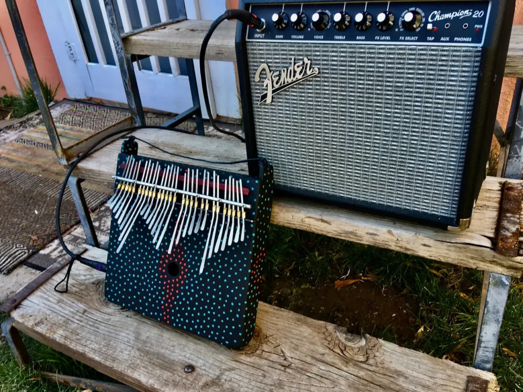 A guitar amplifier sitting on a wooden step.