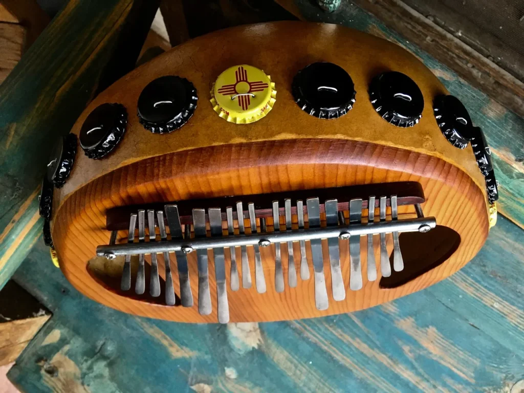 A wooden lamellaphone is sitting on top of a wooden table.