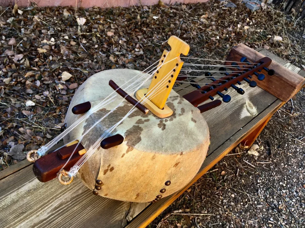 A Ngoma, an African wooden instrument, is sitting on top of a wooden bench.