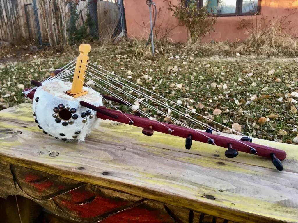 An Ngoma, a wooden instrument used in African music, sitting on top of a wooden table.