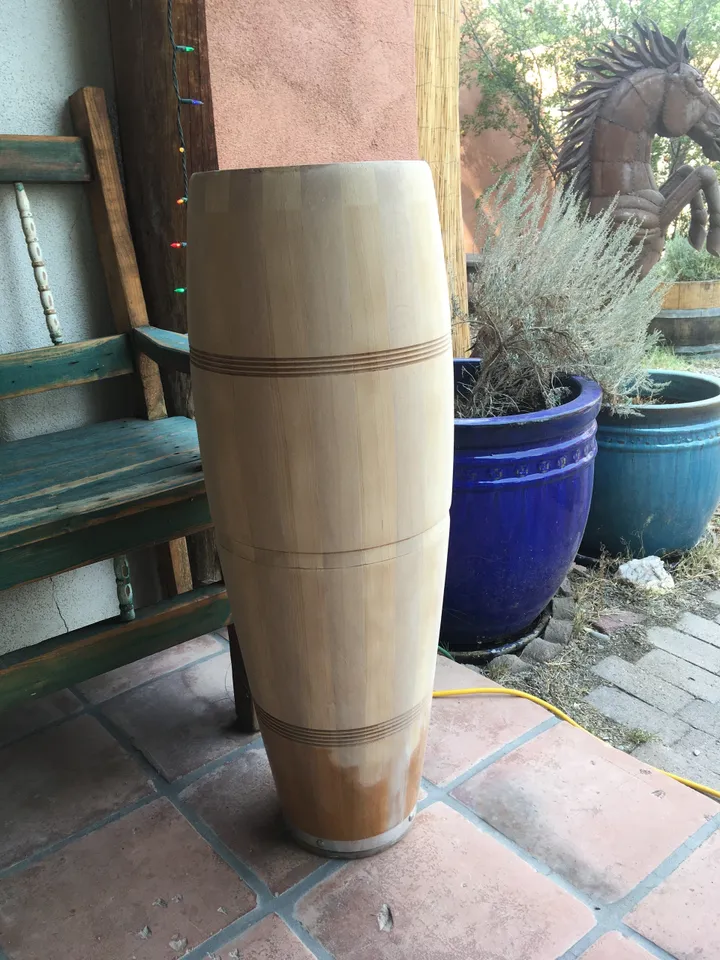 A wooden barrel crafted from Ilimba wood sitting on a Kongoma patio.