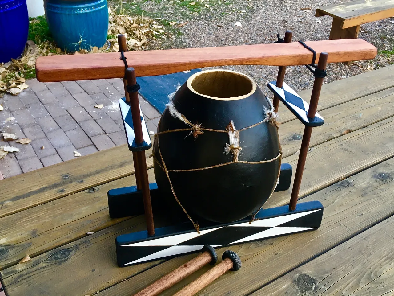 A black and white vase on a wooden table.