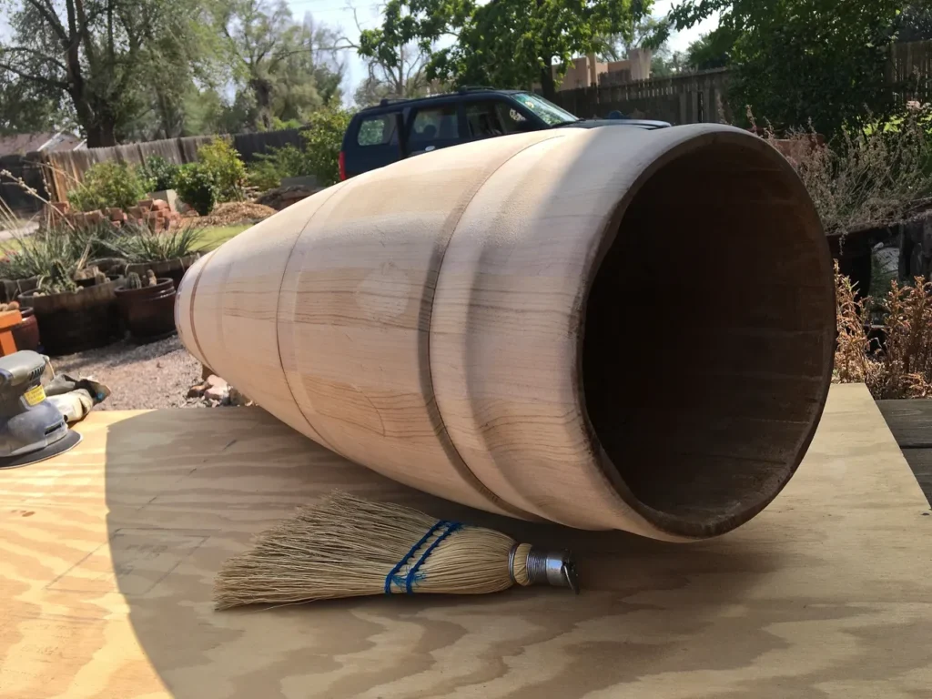 An Ilimba wooden barrel sitting on top of a Kongoma wooden table.