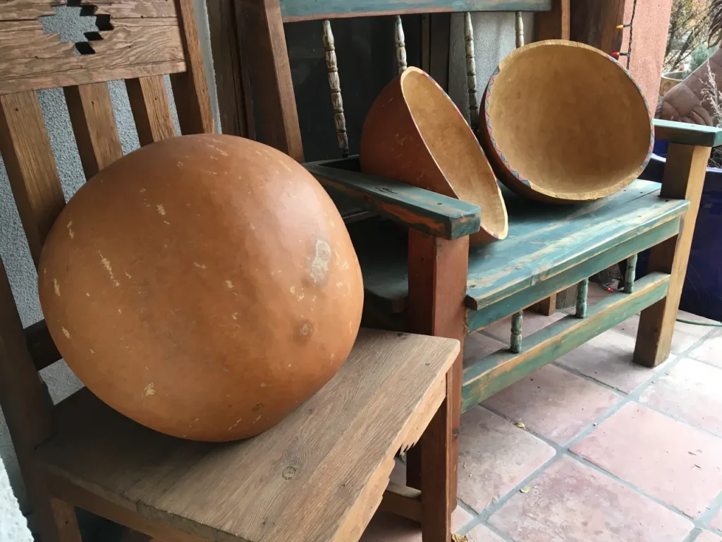 Two Ngoma drums sitting on a wooden bench.