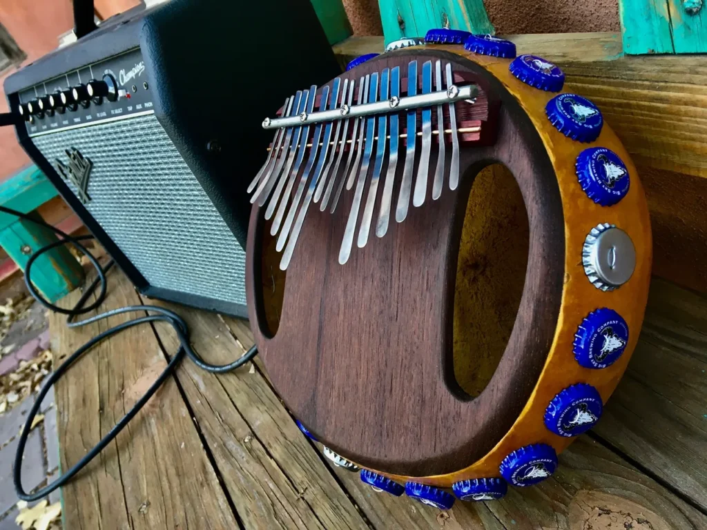 An Ilimba, a type of African harp, is sitting on a wooden deck.