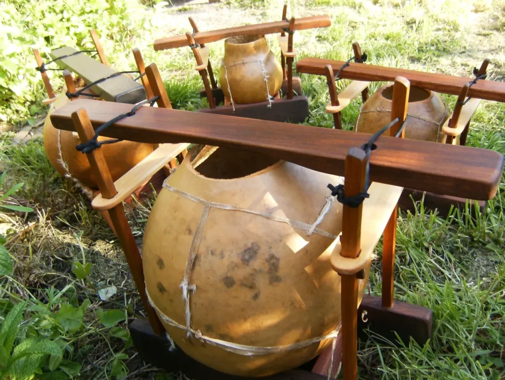 A group of lamellaphone drums sitting in the grass.