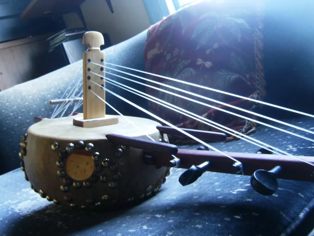 A Ngoma, a traditional African wooden instrument, is sitting on top of a couch.