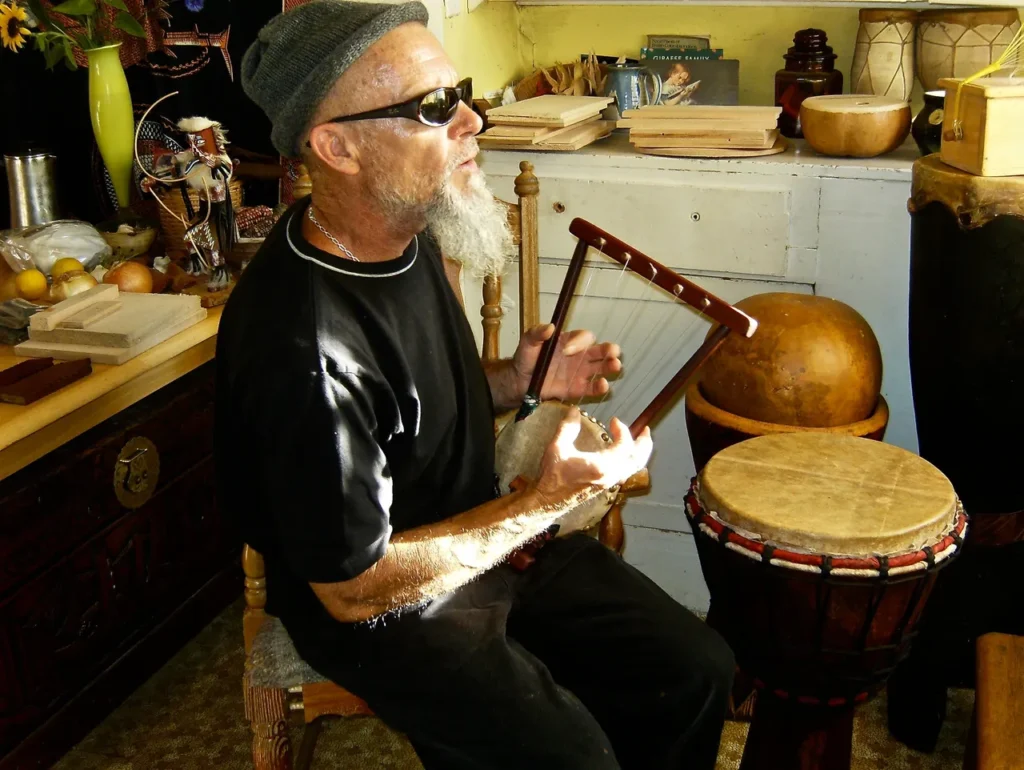 A man playing an African drum.