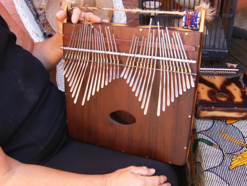 A woman holding a marimbula.