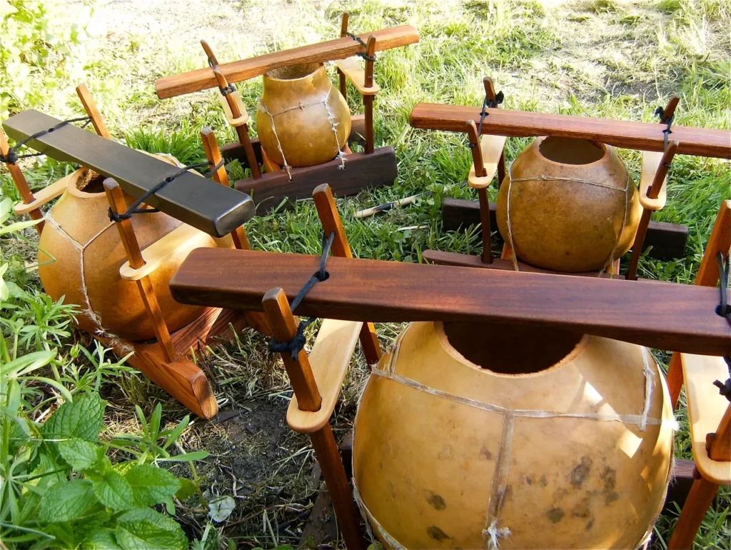 A group of wooden lamellaphones sitting in the grass.