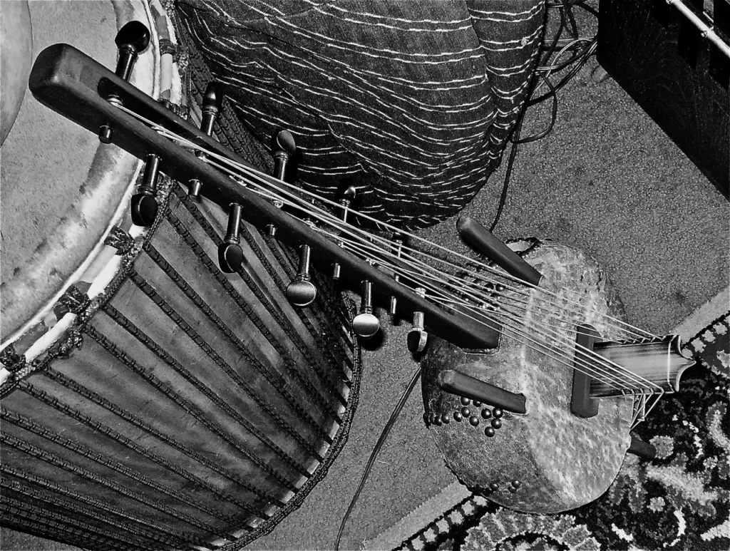          A black and white photo featuring a drum and a guitar, showcasing the captivating essence of Ngoma—a powerful expression of African music.