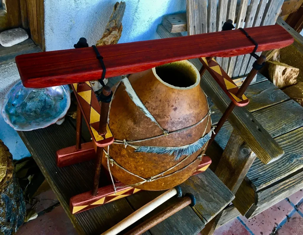 A wooden lamellaphone drum sits on a wooden bench.