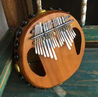 A wooden ukulele is sitting on top of a wooden bench.